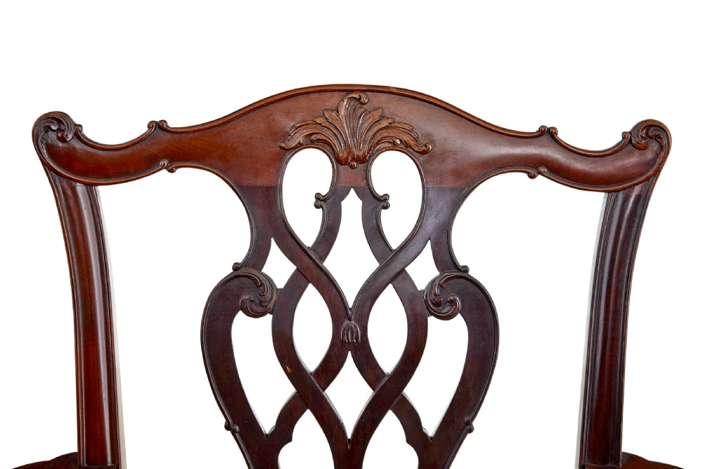 A pair of early 20th-century Chippendale Revival mahogany armchairs featuring carved pierced splat backs, serpentine top rails, curved arms, and cabriole legs. View IV