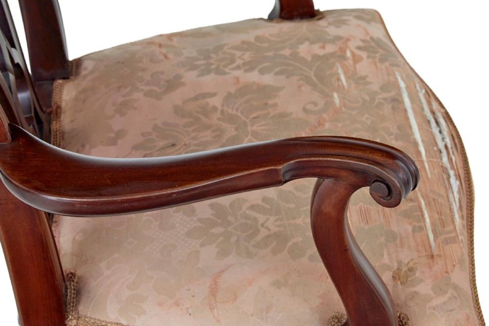 A pair of early 20th-century Chippendale Revival mahogany armchairs featuring carved pierced splat backs, serpentine top rails, curved arms, and cabriole legs. View V