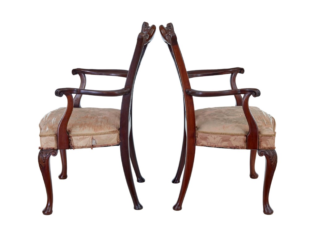 A pair of early 20th-century Chippendale Revival mahogany armchairs featuring carved pierced splat backs, serpentine top rails, curved arms, and cabriole legs. View VI