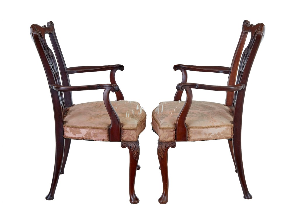 A pair of early 20th-century Chippendale Revival mahogany armchairs featuring carved pierced splat backs, serpentine top rails, curved arms, and cabriole legs. View VII