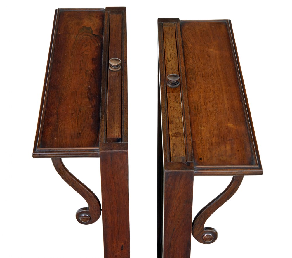 A pair of Regency palisander fire screens with turned stretchers, splayed scroll feet, and central oval floral needlepoint panels. View II
