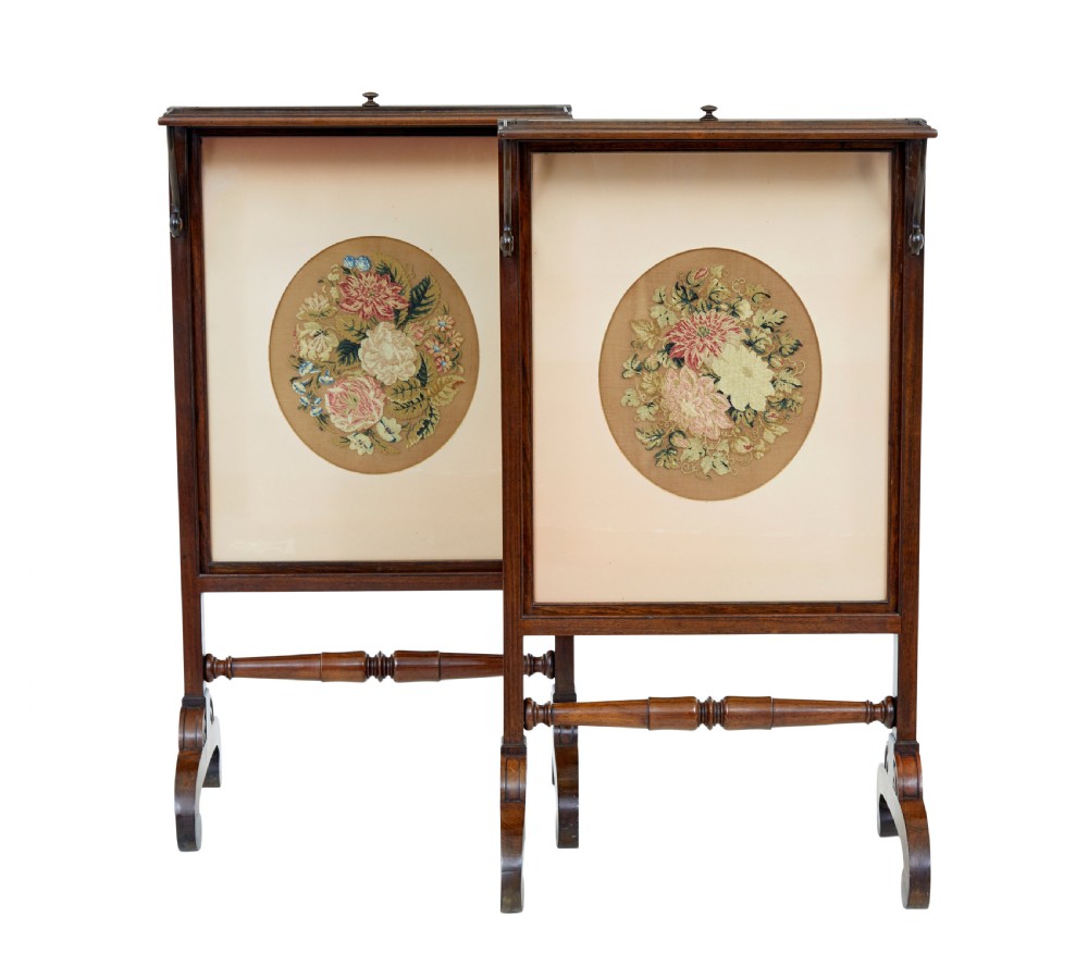 A pair of Regency palisander fire screens with turned stretchers, splayed scroll feet, and central oval floral needlepoint panels. View III