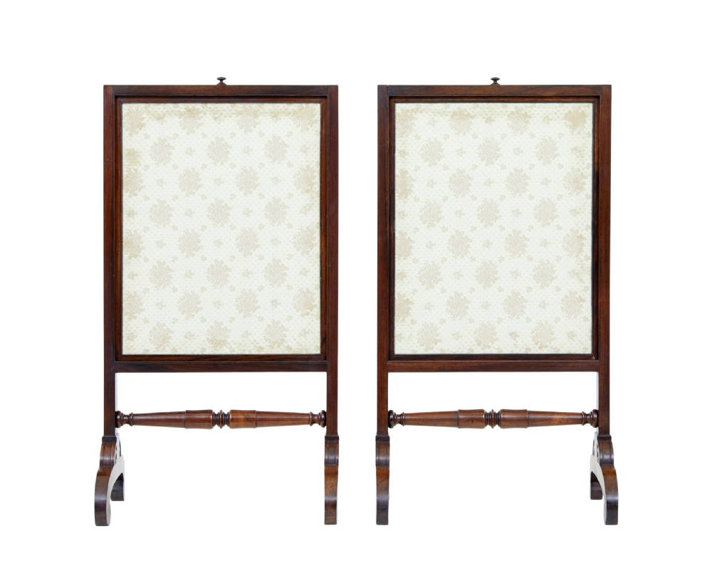 A pair of Regency palisander fire screens with turned stretchers, splayed scroll feet, and central oval floral needlepoint panels. View VI