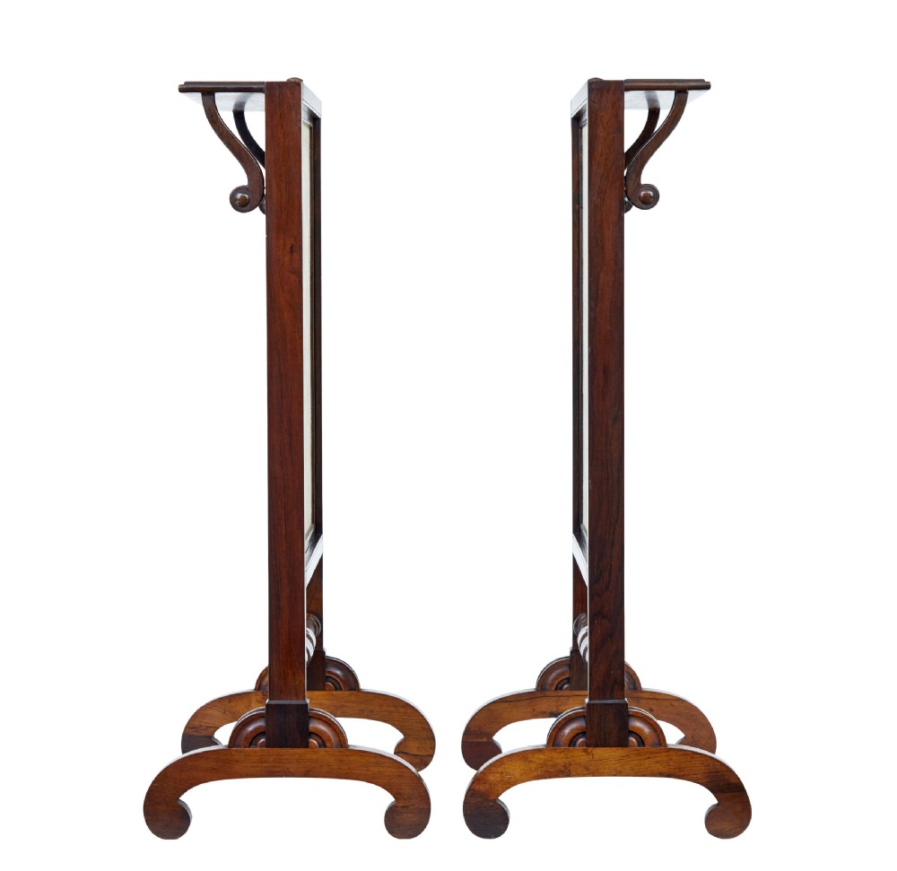 A pair of Regency palisander fire screens with turned stretchers, splayed scroll feet, and central oval floral needlepoint panels. View VII