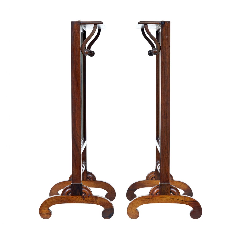 A pair of Regency palisander fire screens with turned stretchers, splayed scroll feet, and central oval floral needlepoint panels. View VIII
