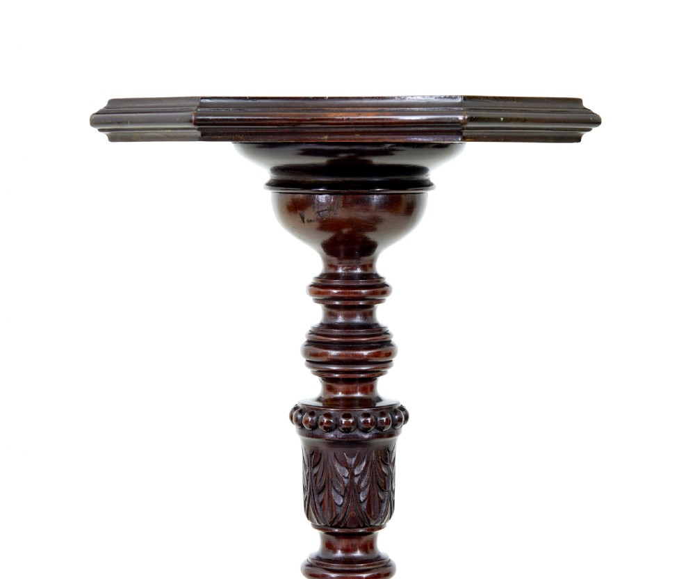 An early 20th-century carved mahogany torchere stand featuring a shaped top, a fluted column with acanthus leaf details, and a tripod base with pad feet. View II