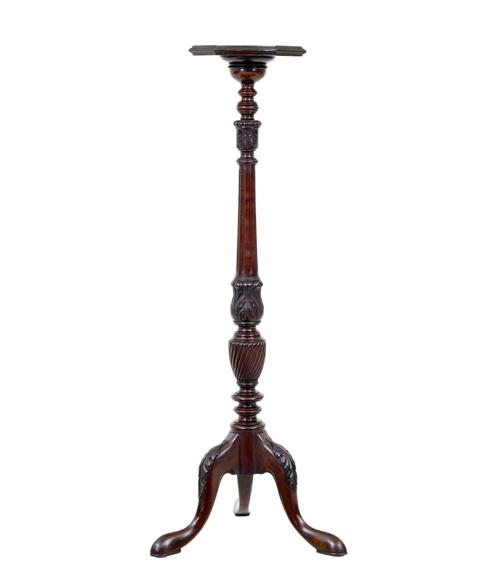 An early 20th-century carved mahogany torchere stand featuring a shaped top, a fluted column with acanthus leaf details, and a tripod base with pad feet. View IV