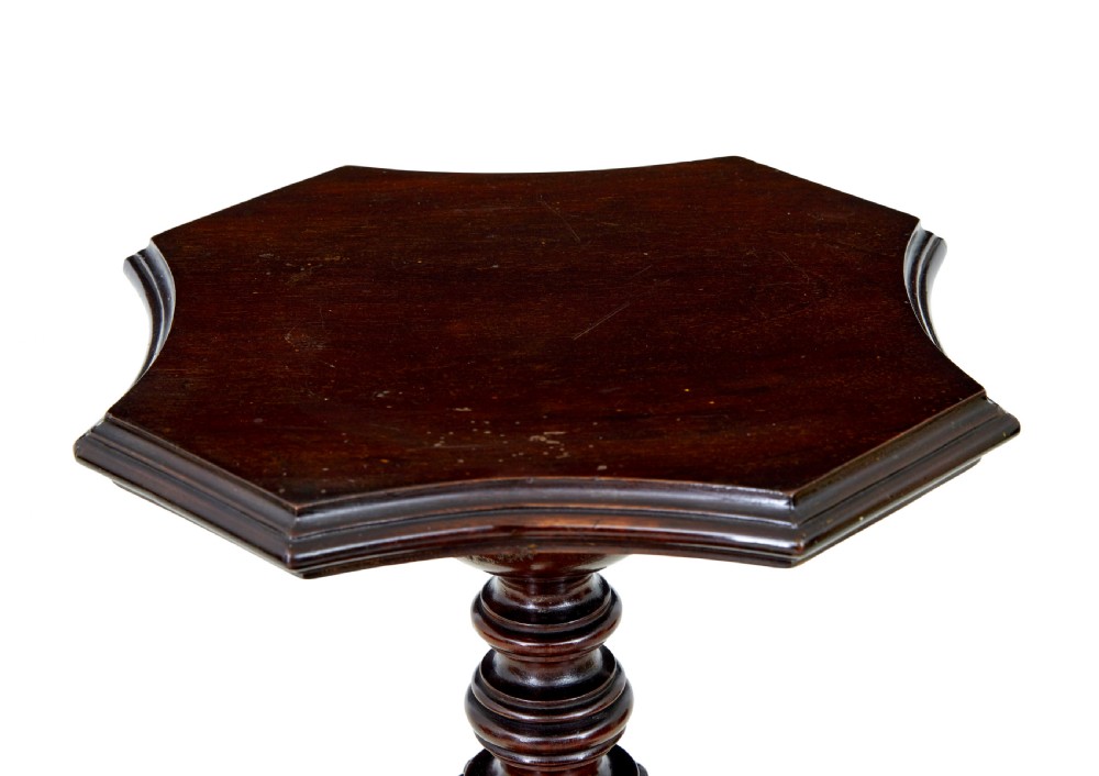 An early 20th-century carved mahogany torchere stand featuring a shaped top, a fluted column with acanthus leaf details, and a tripod base with pad feet. View V
