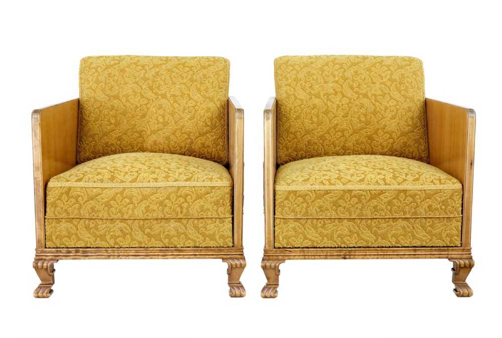 A pair of Art Deco lounge armchairs featuring light birch and elm veneered side panels, golden yellow patterned upholstery, and carved wooden feet. View VII
