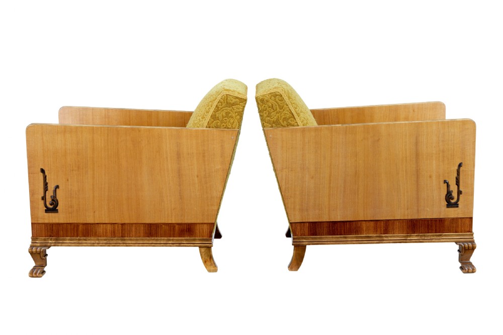 A pair of Art Deco lounge armchairs featuring light birch and elm veneered side panels, golden yellow patterned upholstery, and carved wooden feet. View VIII