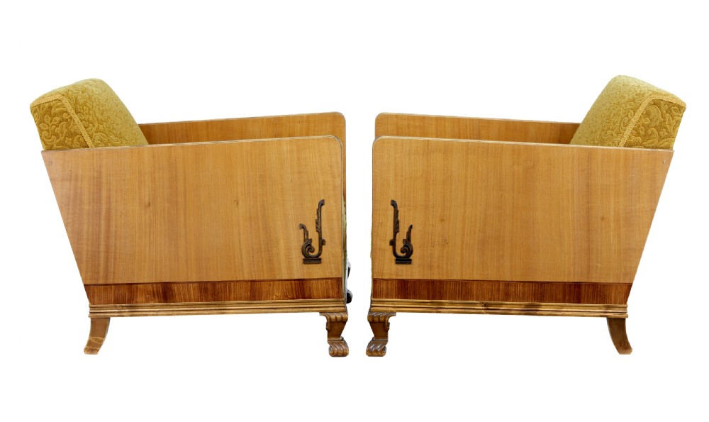 A pair of Art Deco lounge armchairs featuring light birch and elm veneered side panels, golden yellow patterned upholstery, and carved wooden feet. View IX