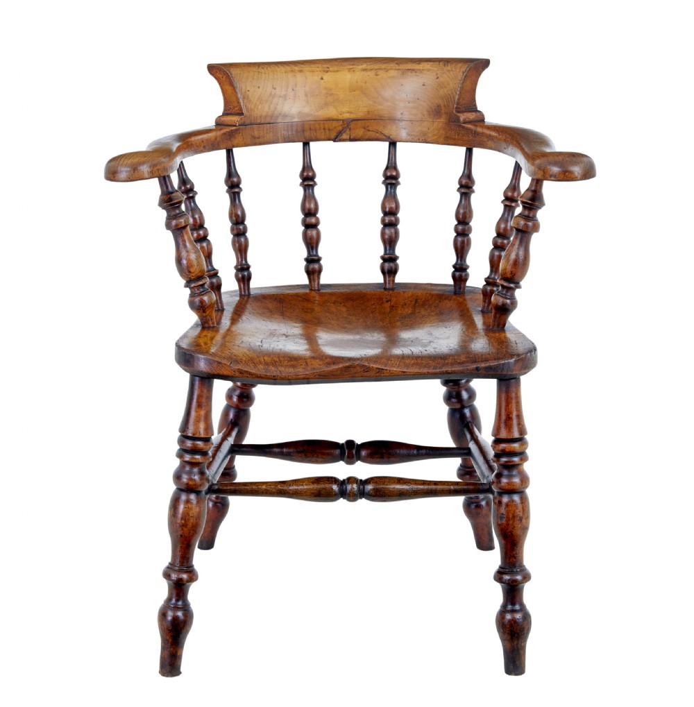 A mid-19th-century Victorian elm captains armchair with turned spindles, a contoured wooden seat, and turned legs. View II