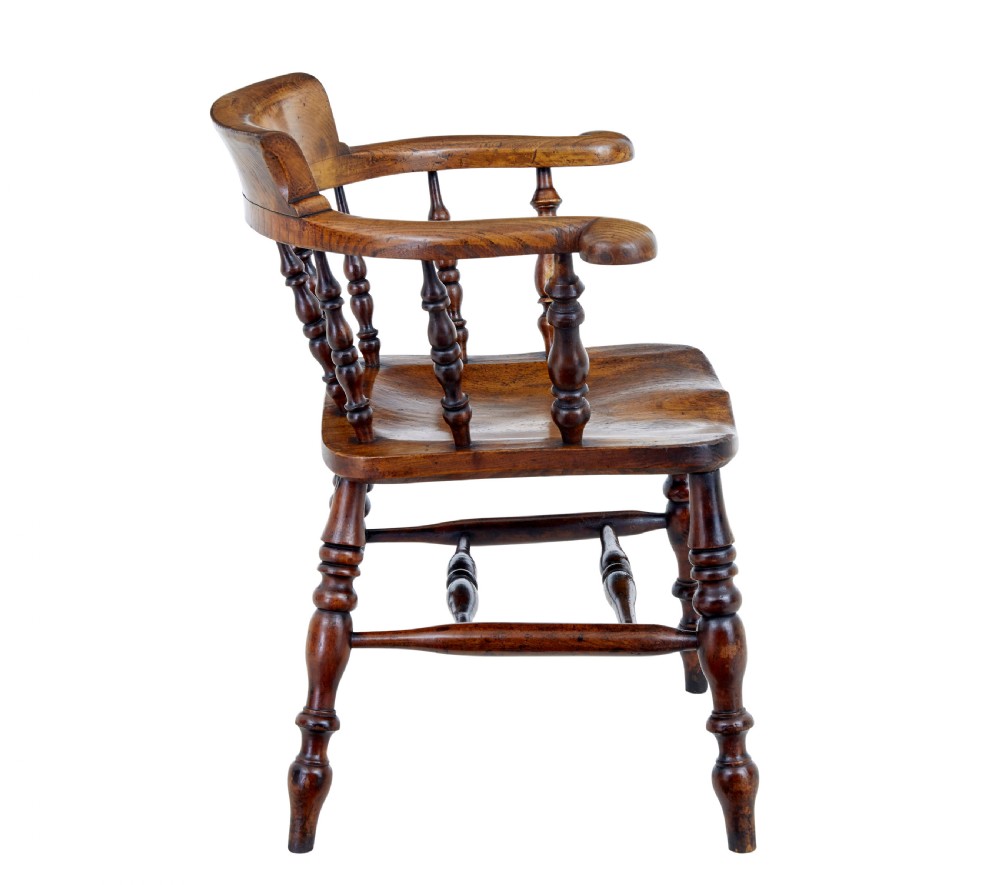 A mid-19th-century Victorian elm captains armchair with turned spindles, a contoured wooden seat, and turned legs. View IV
