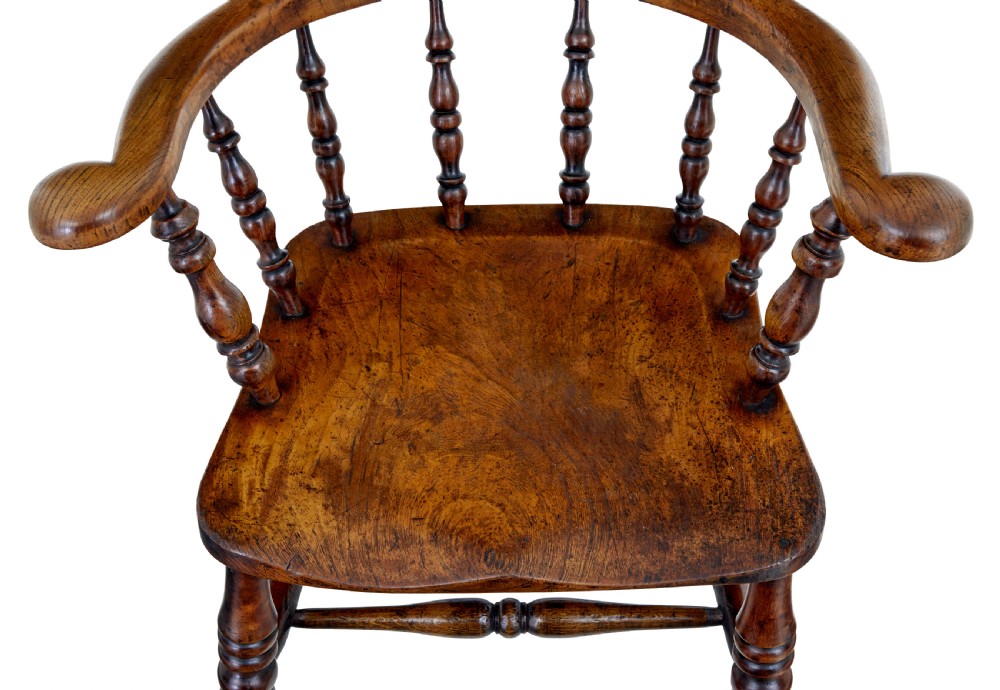 A mid-19th-century Victorian elm captains armchair with turned spindles, a contoured wooden seat, and turned legs. View VII