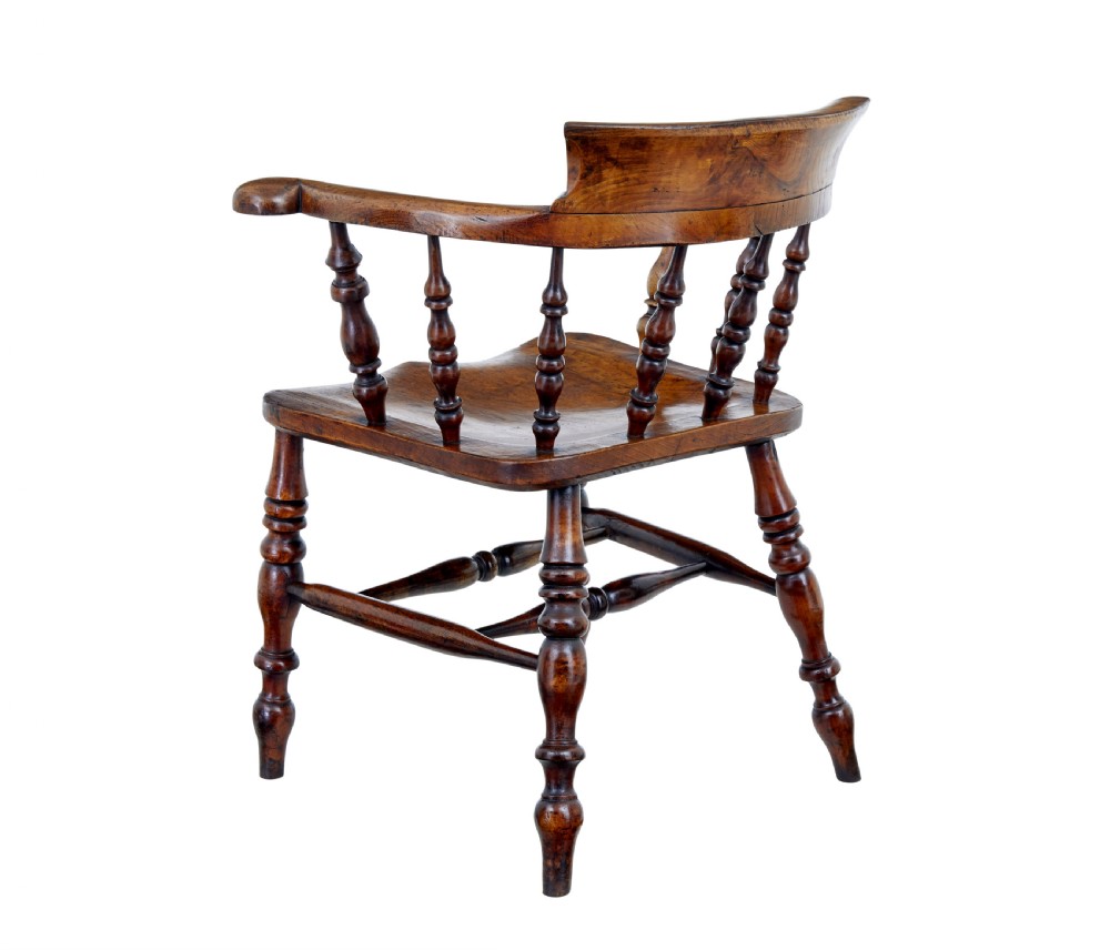 A mid-19th-century Victorian elm captains armchair with turned spindles, a contoured wooden seat, and turned legs. View VIII