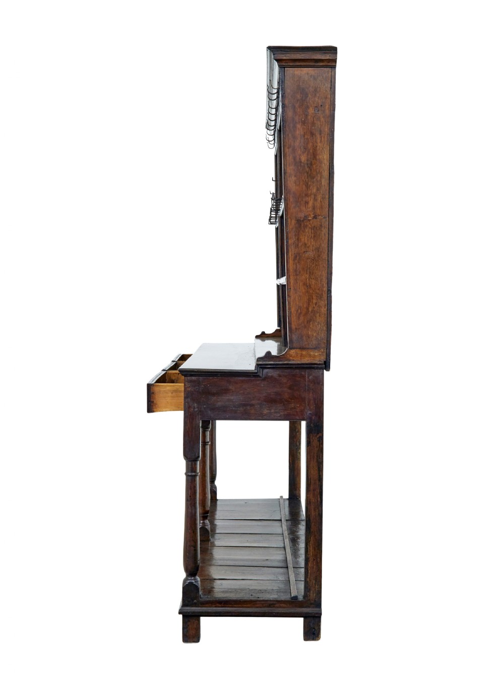 An early nineteenth-century Welsh oak dresser featuring a tall open plate rack with hooks above a three-drawer base supported by turned front legs and a lower pot board. View IV