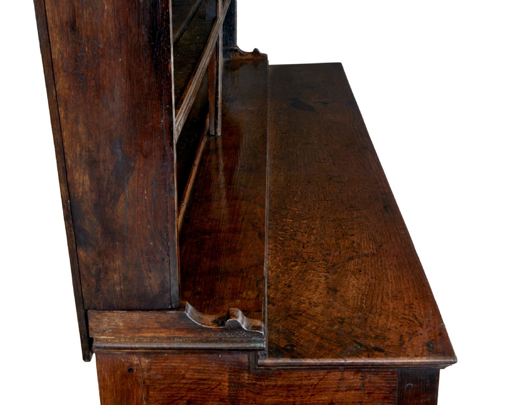 An early nineteenth-century Welsh oak dresser featuring a tall open plate rack with hooks above a three-drawer base supported by turned front legs and a lower pot board. View VIII
