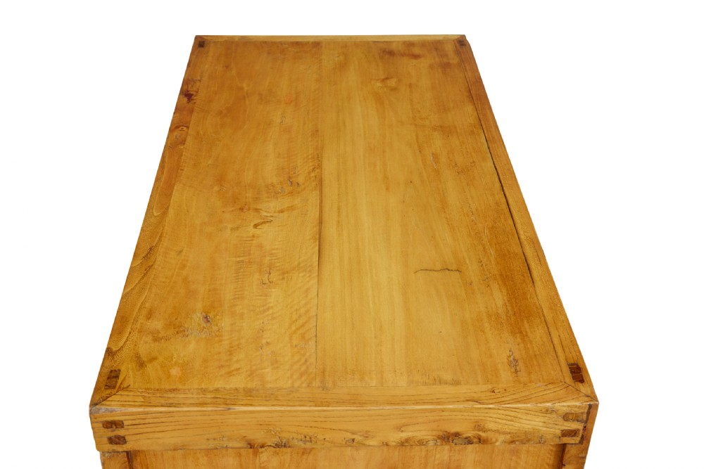 A late nineteenth-century light wood Chinese sideboard featuring three upper drawers over a double-door cupboard with circular brass faceplates. View II