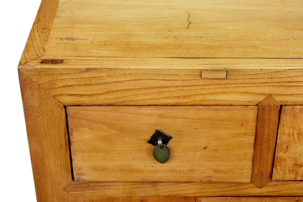 A late nineteenth-century light wood Chinese sideboard featuring three upper drawers over a double-door cupboard with circular brass faceplates. View IV