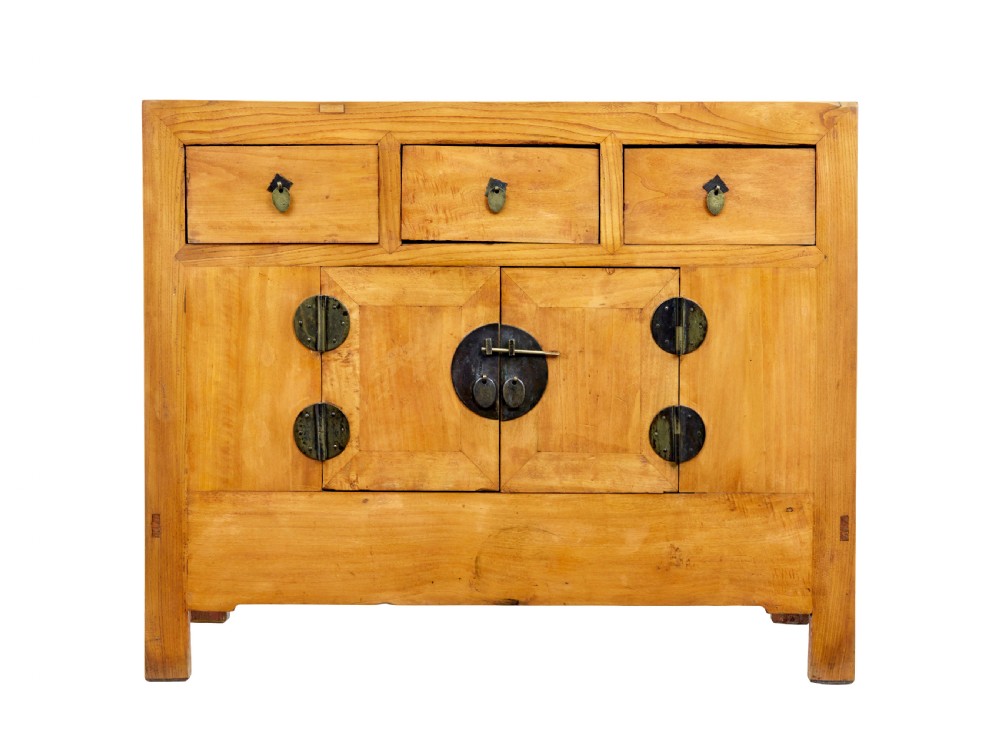 A late nineteenth-century light wood Chinese sideboard featuring three upper drawers over a double-door cupboard with circular brass faceplates. View V