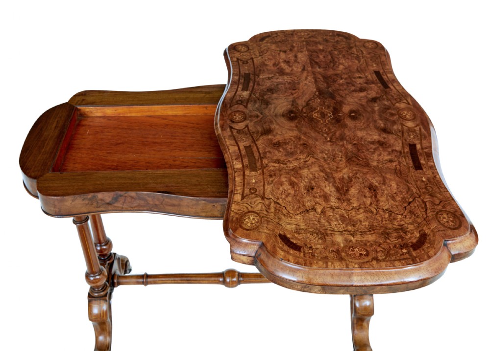 A 19th-century Victorian walnut fold-over card table featuring turned dual pedestal legs, a central stretcher rail, scroll feet, and ceramic castors. View VIII