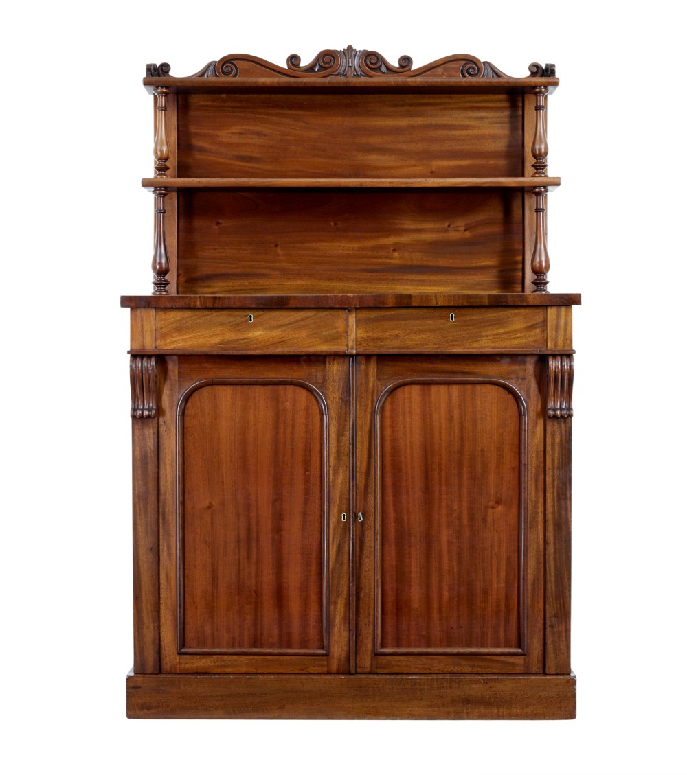 A 19th-century French mahogany chiffonier sideboard with a top display shelf supported by turned spindles, scrolled cresting, two drawers, and a double cupboard base. View II
