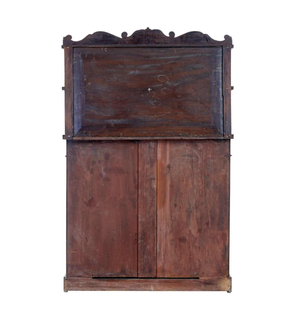 A 19th-century French mahogany chiffonier sideboard with a top display shelf supported by turned spindles, scrolled cresting, two drawers, and a double cupboard base. View V