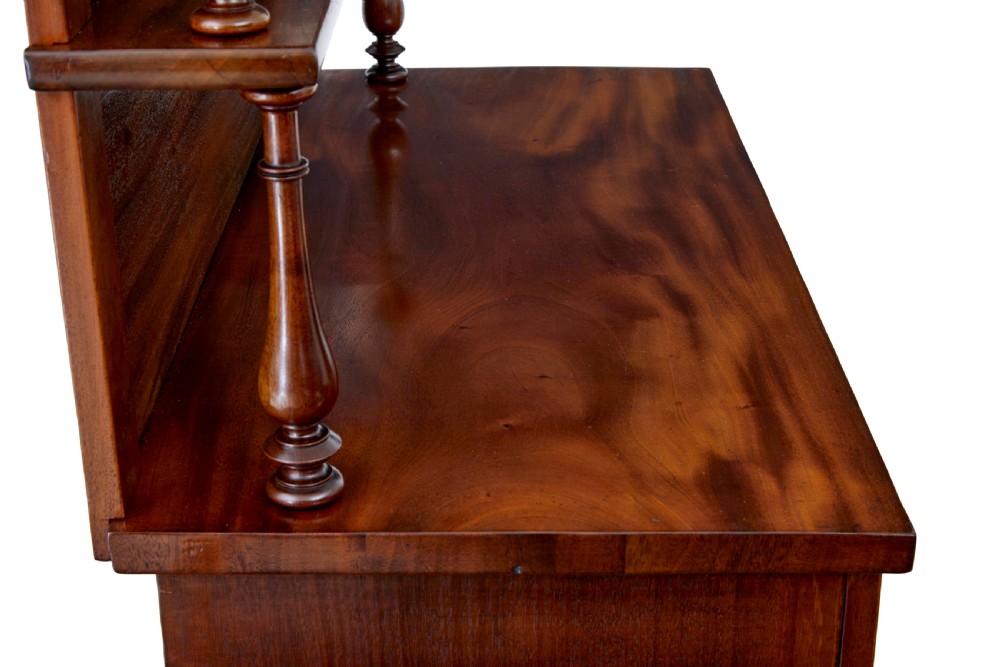 A 19th-century French mahogany chiffonier sideboard with a top display shelf supported by turned spindles, scrolled cresting, two drawers, and a double cupboard base. View VII
