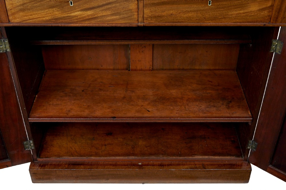 A 19th-century French mahogany chiffonier sideboard with a top display shelf supported by turned spindles, scrolled cresting, two drawers, and a double cupboard base. View IX