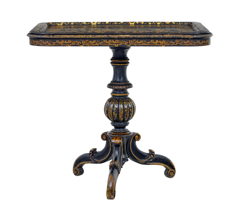A 19th-century black lacquered pedestal table featuring hand-painted gold chinoiserie motifs, a tray top, turned central column, and tripod feet.