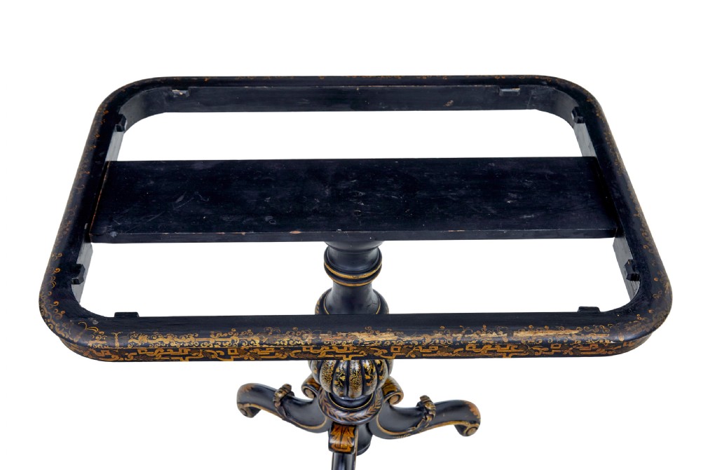 A 19th-century black lacquered pedestal table featuring hand-painted gold chinoiserie motifs, a tray top, turned central column, and tripod feet. View VI