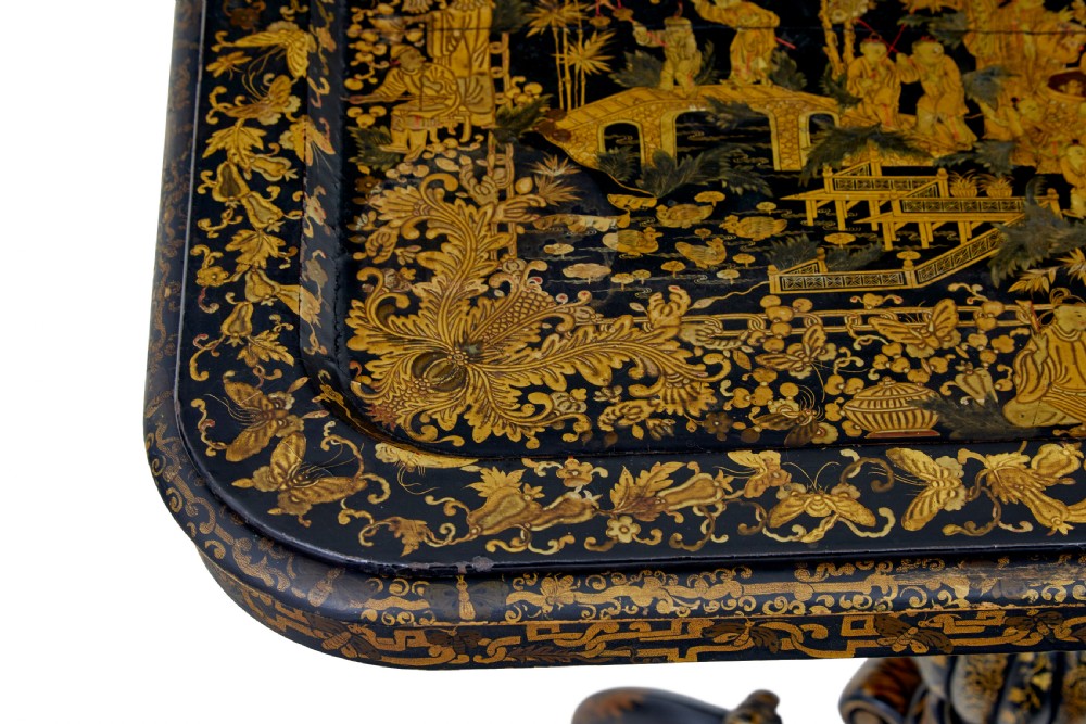 A 19th-century black lacquered pedestal table featuring hand-painted gold chinoiserie motifs, a tray top, turned central column, and tripod feet. View VII