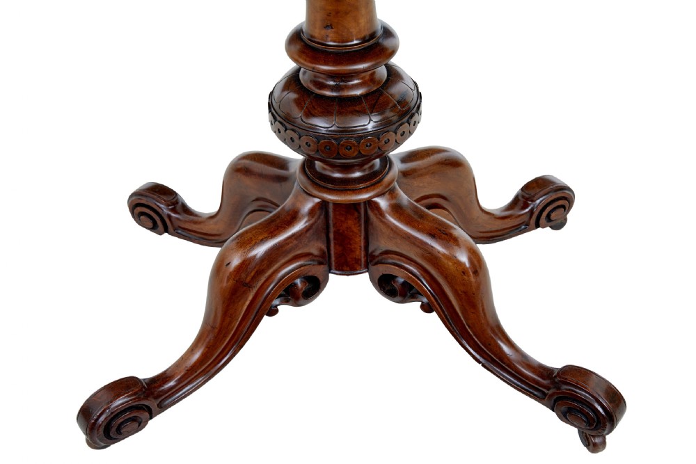 A 19th-century carved walnut fold-over card table featuring an ebonised top edge, a turned central stem, and four carved scroll feet with castors. View VIII