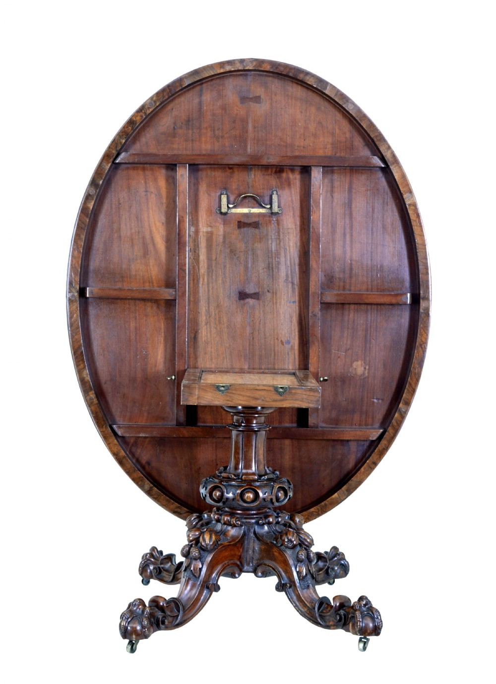 A 19th-century oval walnut tilt-top table with intricate floral marquetry inlay and a carved pedestal base with brass castors. View IV