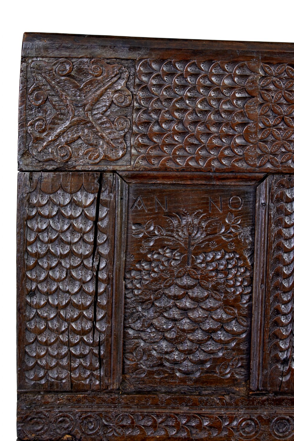 A dark carved oak bench featuring a high panelled back with intricate relief carvings and splayed trestle legs. View VIII