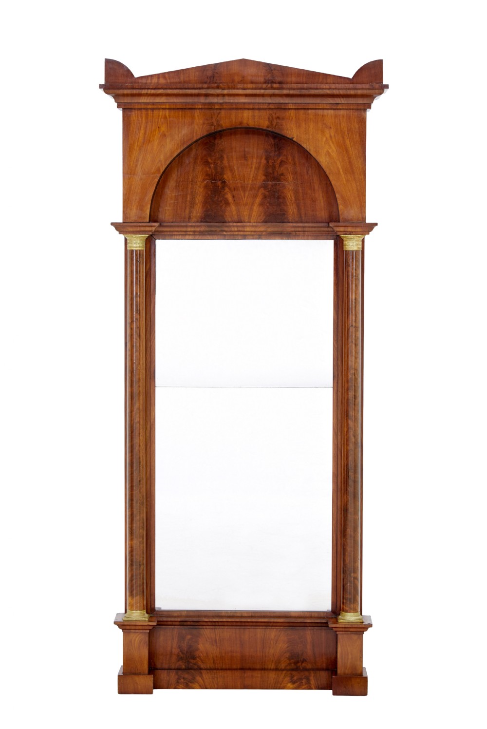 A tall nineteenth-century Empire Revival mahogany pier mirror featuring an architectural pediment, recessed arch with flame mahogany veneer, and flanking columns with gilded capitals.