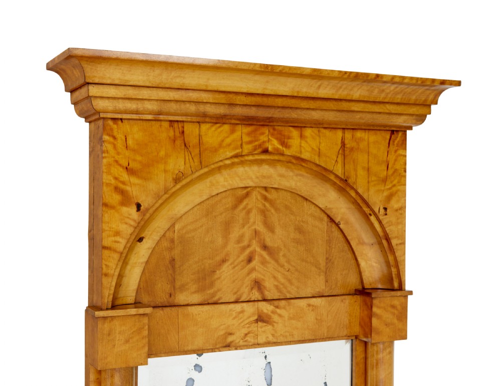 A tall nineteenth-century Swedish Empire revival flame birch pier mirror featuring an arched crest panel, fluted side columns, and a moulded top cornice. View II