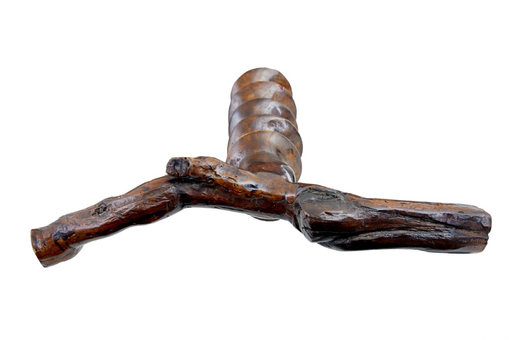 A hand-carved dark wood corkscrew featuring a carved spiral helix and an ergonomic, naturalistic wooden handle. View II
