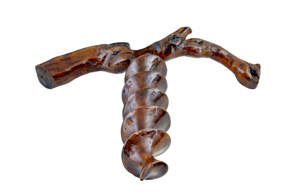 A hand-carved dark wood corkscrew featuring a carved spiral helix and an ergonomic, naturalistic wooden handle. View III