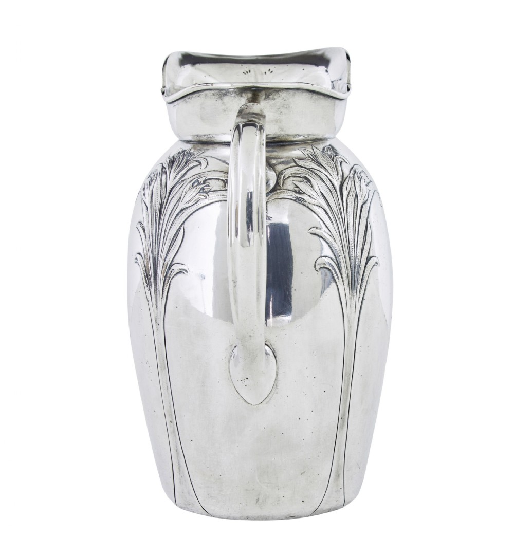 An Art Nouveau silver-plated ewer jug and matching basin set made by Christofle featuring relief-carved botanical foliage details. View V