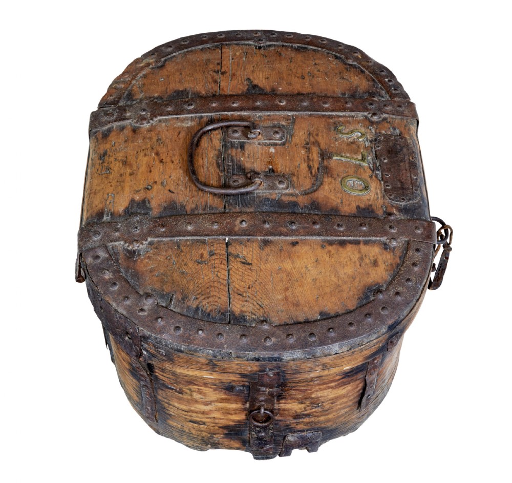 An early 18th-century Scandinavian oval oak box featuring wrought iron binding straps, studded rivets, and carved initials on the top. View VI