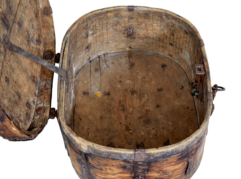An early 18th-century Scandinavian oval oak box featuring wrought iron binding straps, studded rivets, and carved initials on the top. View VII