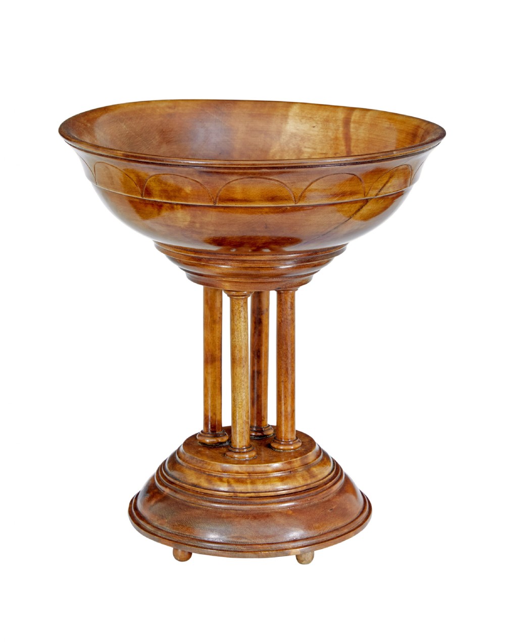 A 19th-century carved walnut tazza featuring a shallow turned bowl resting on slender columnar supports and a stepped circular base.