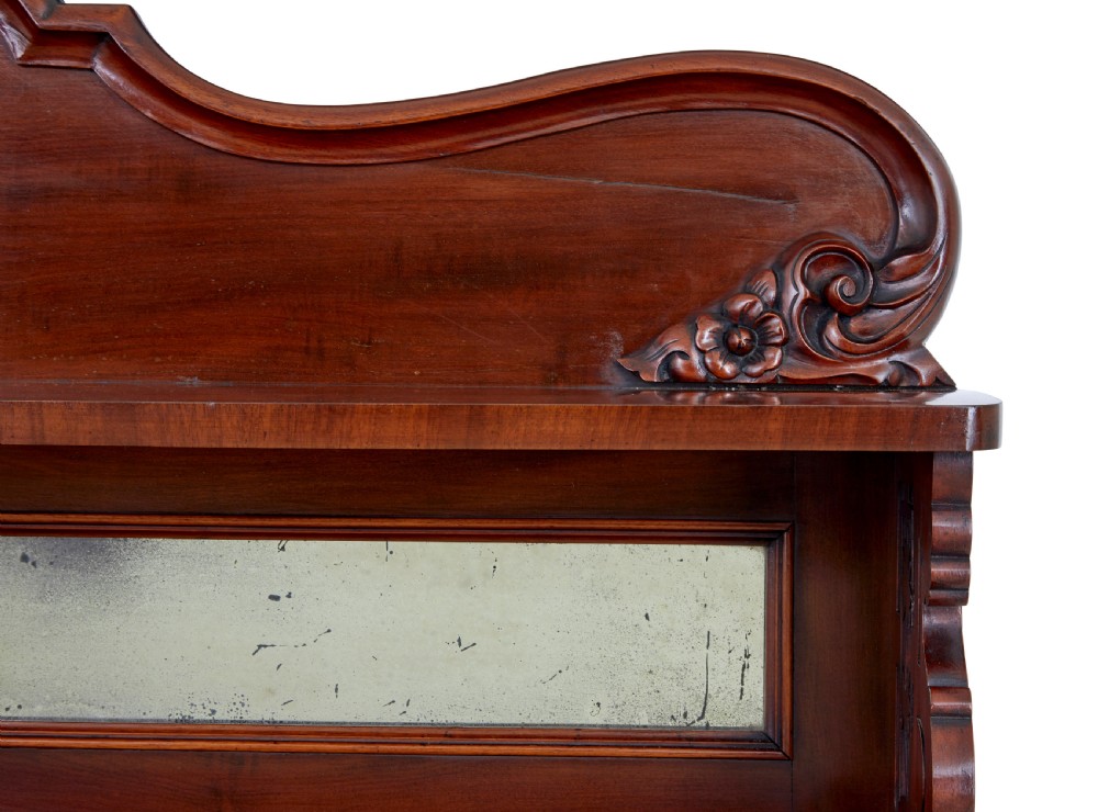 A 19th-century French mahogany chiffonier sideboard featuring a carved pediment upper tier with inset mirror panels over a two-door base cabinet. View VII