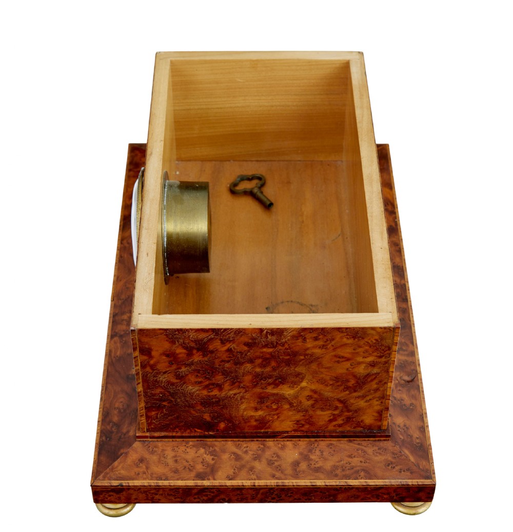 An early 20th-century burr yew desktop box featuring a circular clock face on the front, gilt brass top ornamentation, and brass feet. View VIII