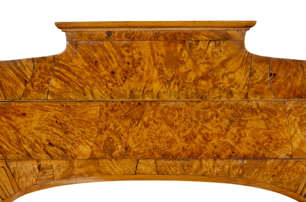 A nineteenth-century Biedermeier mantle mirror featuring a figured root birch veneer frame with a stepped crest and carved fan spandrel details. View III
