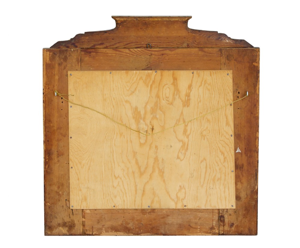 A nineteenth-century Biedermeier mantle mirror featuring a figured root birch veneer frame with a stepped crest and carved fan spandrel details. View V