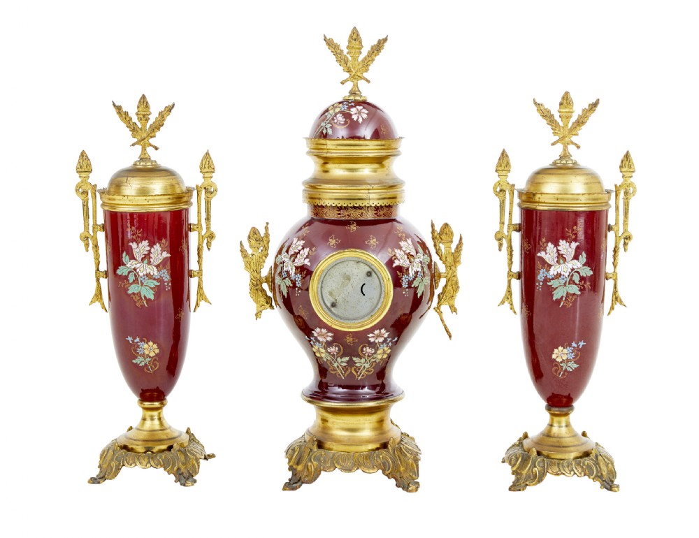 A nineteenth-century three-piece French toleware garniture set comprising a central clock urn and two matching side urns in crimson with hand-painted flowers and gilt mounts. View III