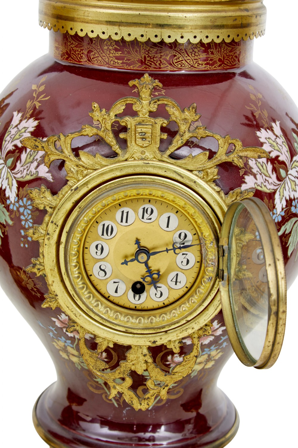 A nineteenth-century three-piece French toleware garniture set comprising a central clock urn and two matching side urns in crimson with hand-painted flowers and gilt mounts. View V