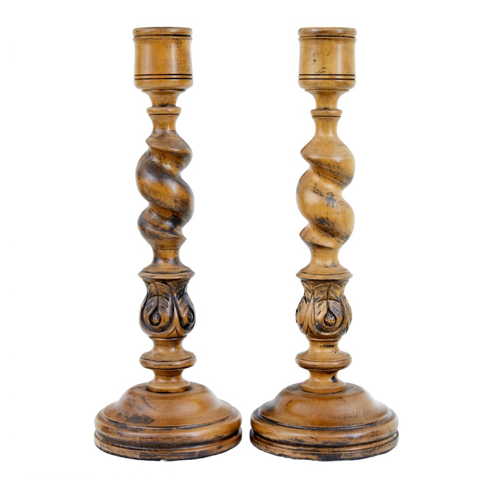 A pair of early 20th-century turned wood candlesticks featuring spiral stems, carved leaf accents, and wide circular bases. View III